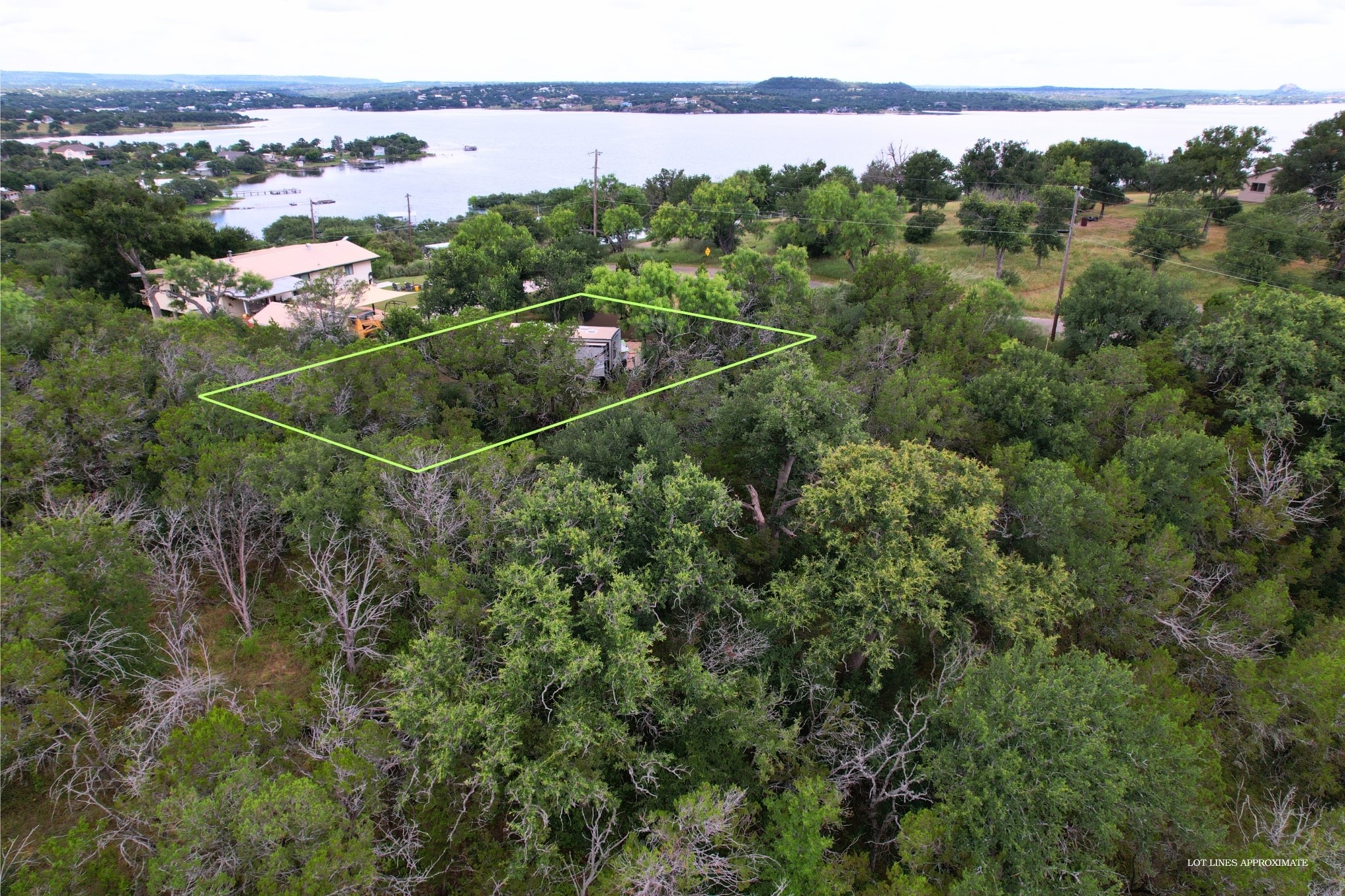 706 Cr138a Road Burnet, TX 78611 - Photo 7 of 18 A tranquil lot overlooking a shimmering lake and surrounding verdant woodlands, ideal for a custom home.