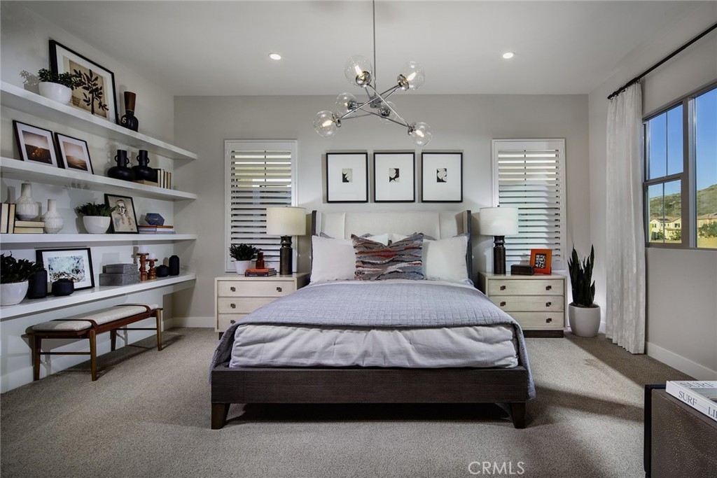 102 EVERSEDGE Irvine, CA 92618 - Photo 4 of 8 a bedroom with a large bed and a chandelier