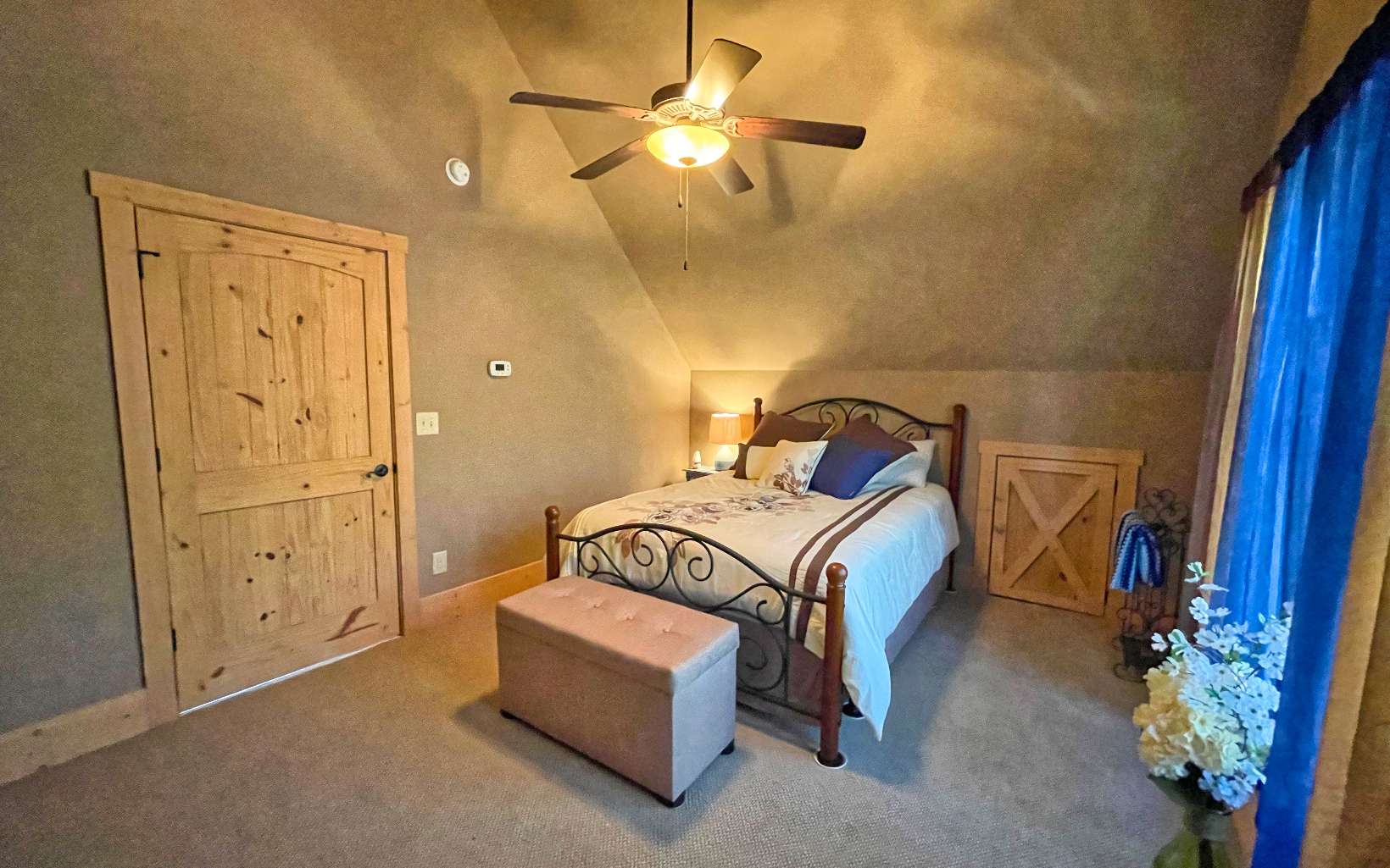 111 Watkins Farm Road Blue Ridge, GA 30513 - Photo 23 of 44 a bedroom with a bed and a chandelier