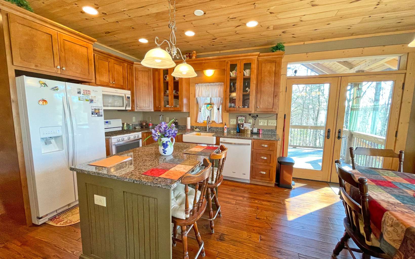 111 Watkins Farm Road Blue Ridge, GA 30513 - Photo 8 of 44 a kitchen with stainless steel appliances granite countertop a refrigerator a sink dishwasher a stove and a dining table with wooden floor