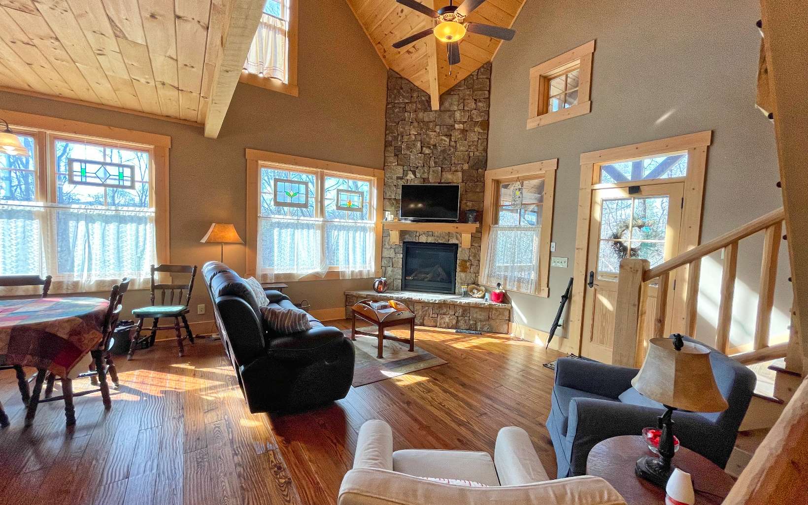 111 Watkins Farm Road Blue Ridge, GA 30513 - Photo 10 of 44 a living room with furniture a fireplace and large windows