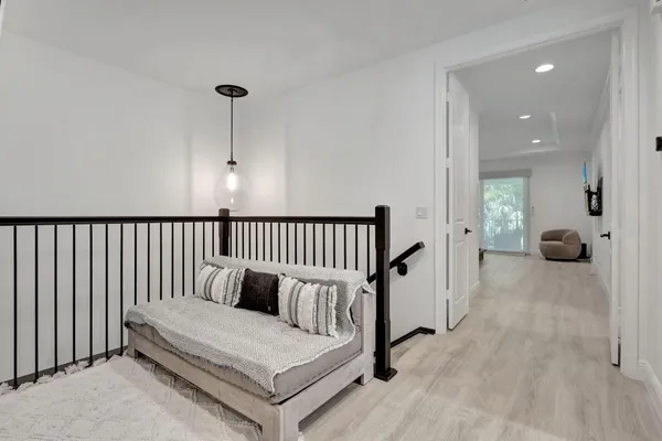 a spacious bedroom with a bed and a chandelier