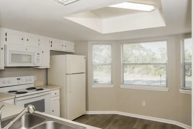 a white refrigerator freezer sitting inside of a kitchen