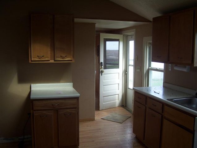 11680 Elston Road Fulton, IL 61252 - Photo 2 of 9 a kitchen with a refrigerator and cabinets