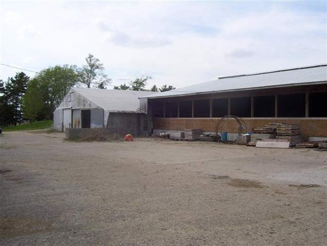 11680 Elston Road Fulton, IL 61252 - Photo 4 of 9 a front view of a house with a yard and garage