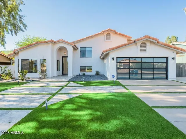 a front view of a house with a yard and garage