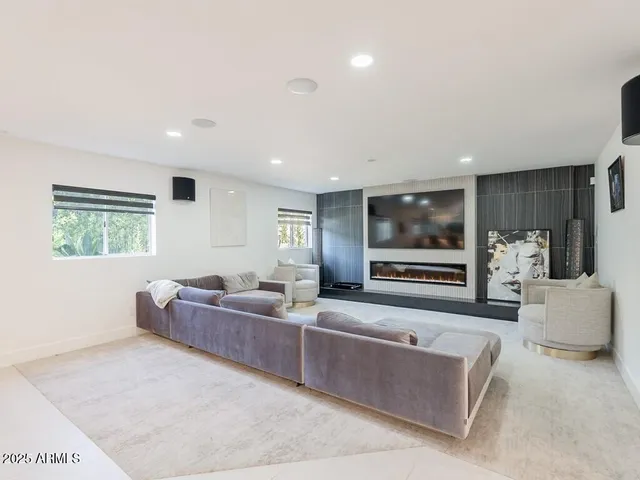 a view of a living room a flat screen tv and a chandelier