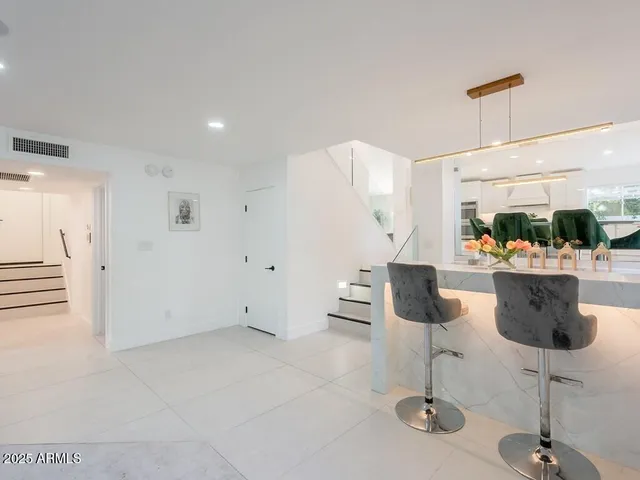 a view of a sink and a large mirror