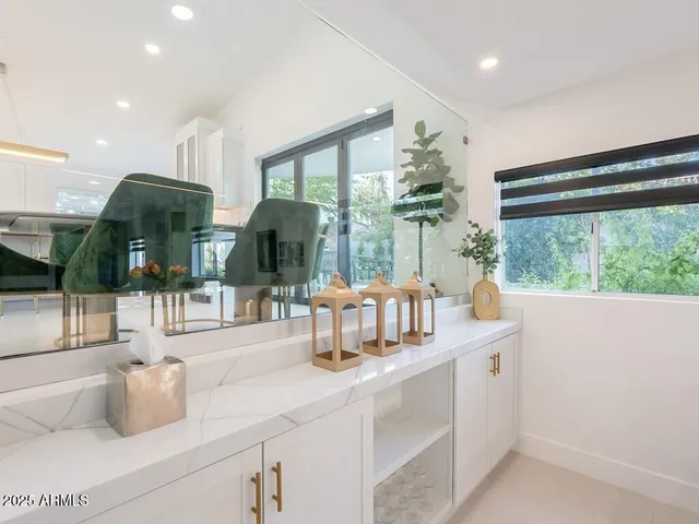 a kitchen with kitchen island a table and chairs in it