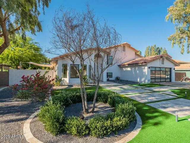 a front view of a house with garden