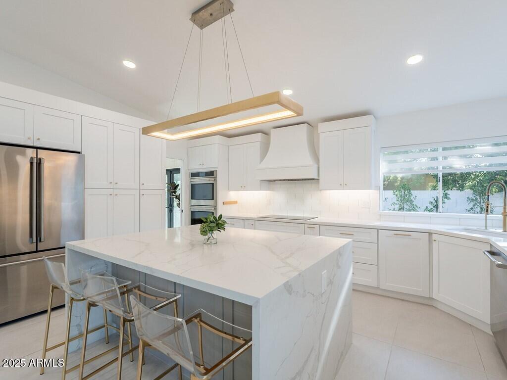 4748 East Redfield Road Phoenix, AZ 85032 - Photo 26 of 73 a kitchen with kitchen island a table and chairs in it
