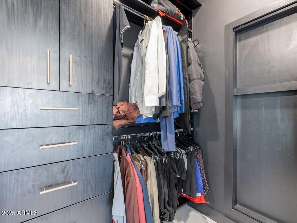 4748 East Redfield Road Phoenix, AZ 85032 - Photo 29 of 73 a view of walk in closet with clothes and shoes