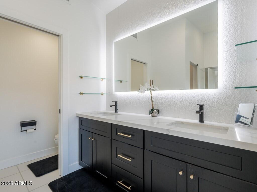 4748 East Redfield Road Phoenix, AZ 85032 - Photo 33 of 73 a bathroom with a double vanity sink and a mirror