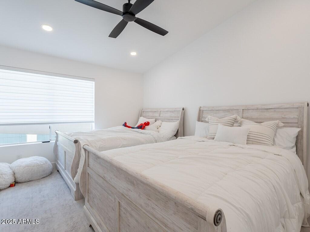 4748 East Redfield Road Phoenix, AZ 85032 - Photo 36 of 73 a bedroom with a bed and a chandelier