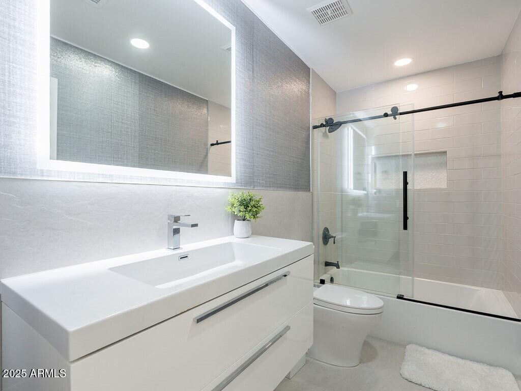 4748 East Redfield Road Phoenix, AZ 85032 - Photo 38 of 73 a bathroom with a sink a toilet and shower