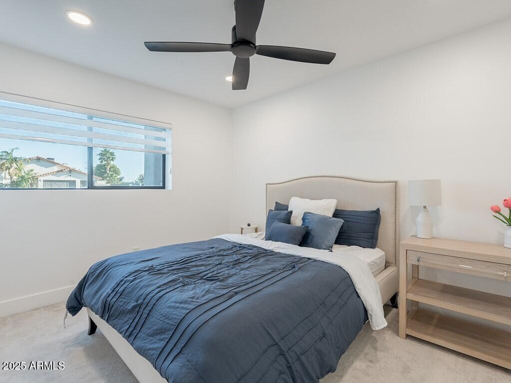 4748 East Redfield Road Phoenix, AZ 85032 - Photo 40 of 73 a bedroom with a bed and a ceiling fan