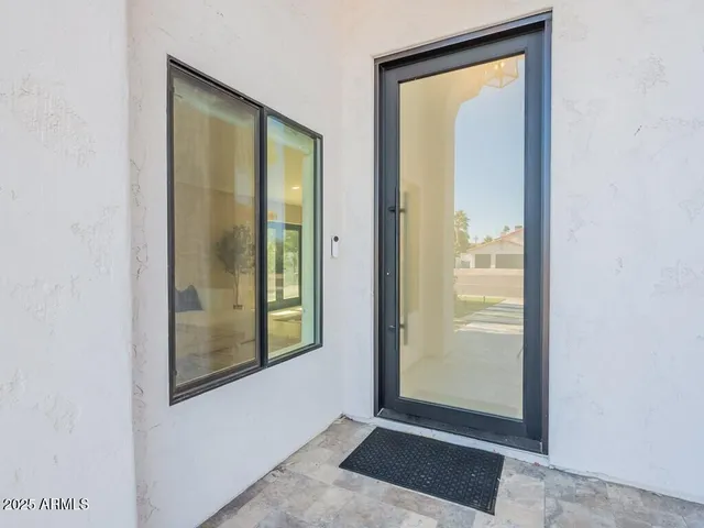 a living room with furniture large window and couch