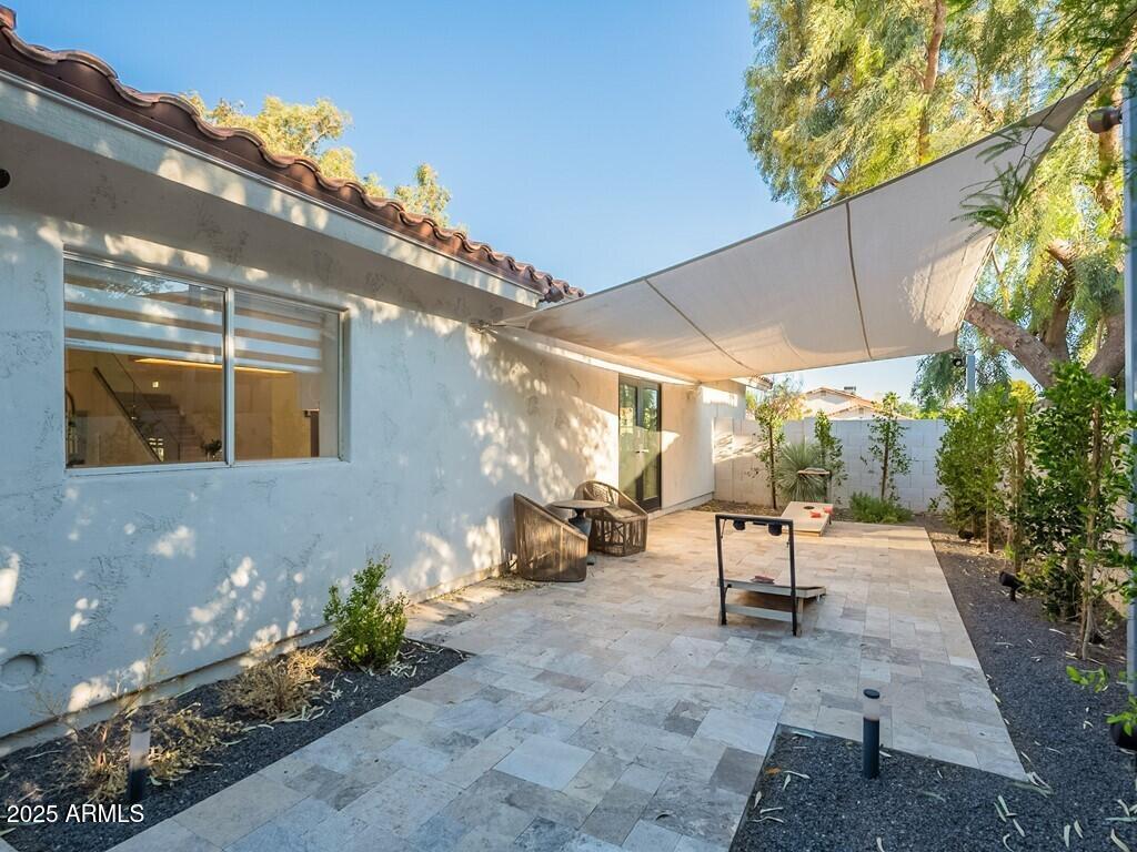 4748 East Redfield Road Phoenix, AZ 85032 - Photo 47 of 73 a view of a patio with table and chairs potted plants