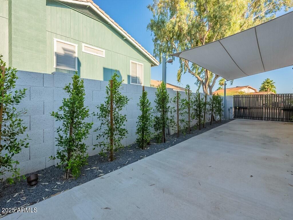4748 East Redfield Road Phoenix, AZ 85032 - Photo 54 of 73 a view of a house with a yard and potted plants