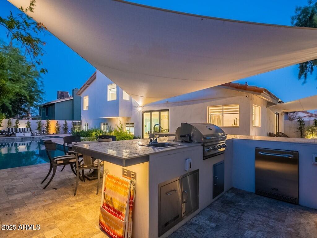 4748 East Redfield Road Phoenix, AZ 85032 - Photo 63 of 73 a kitchen with a stove a refrigerator and a dining table