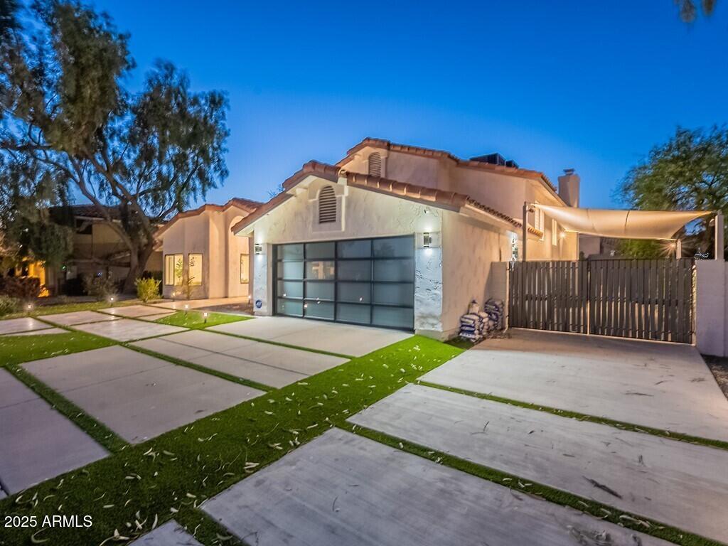 4748 East Redfield Road Phoenix, AZ 85032 - Photo 65 of 73 a front view of a house with a yard and garage