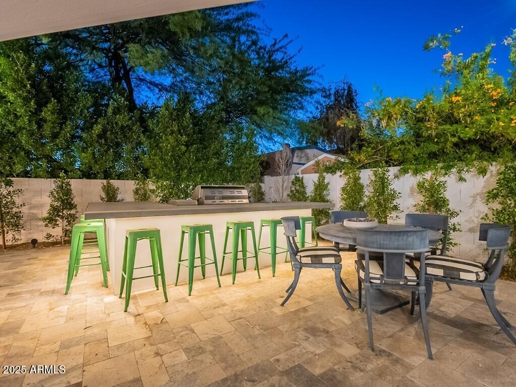 4748 East Redfield Road Phoenix, AZ 85032 - Photo 69 of 73 a view of a patio with table and chairs and potted plants