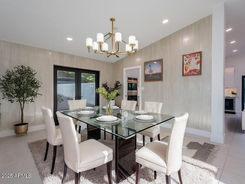 4748 East Redfield Road Phoenix, AZ 85032 - Photo 9 of 73 a view of a dining room with furniture and chandelier