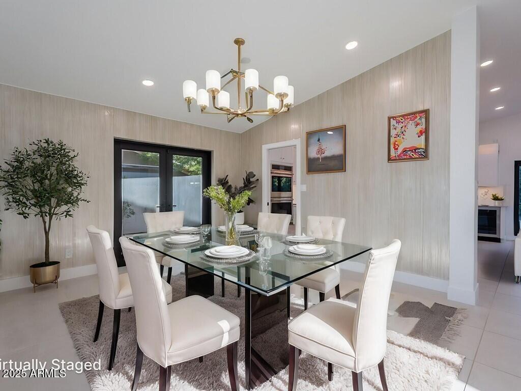 4748 East Redfield Road Phoenix, AZ 85032 - Photo 10 of 73 a view of a dining room with furniture and chandelier