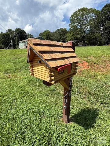 a backyard of a house with lots of green space and plants