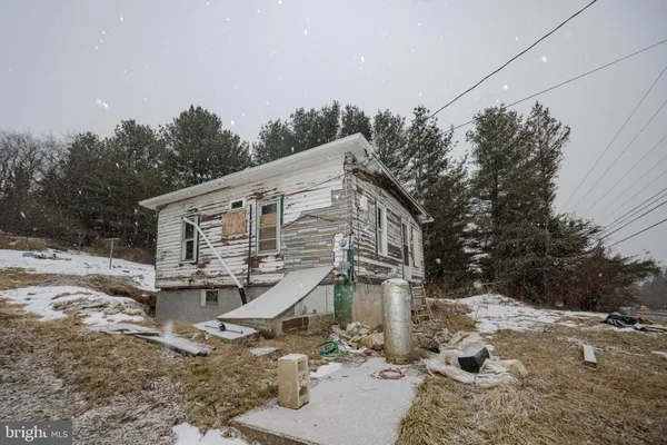 a view of a house with a yard covered in snow