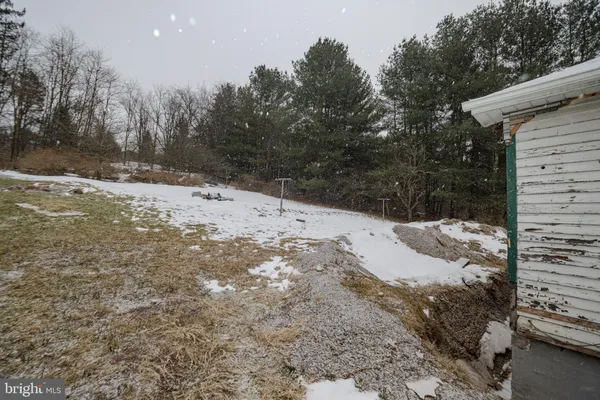 a view of a yard covered in snow