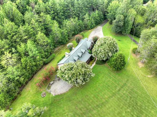 a kitchen with stainless steel appliances granite countertop a refrigerator a sink a stove and dishwasher