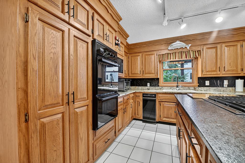 167 Whispering Pne Lane Cherry Log, GA 30522 - Photo 31 of 87 a kitchen with stainless steel appliances granite countertop a refrigerator and a sink