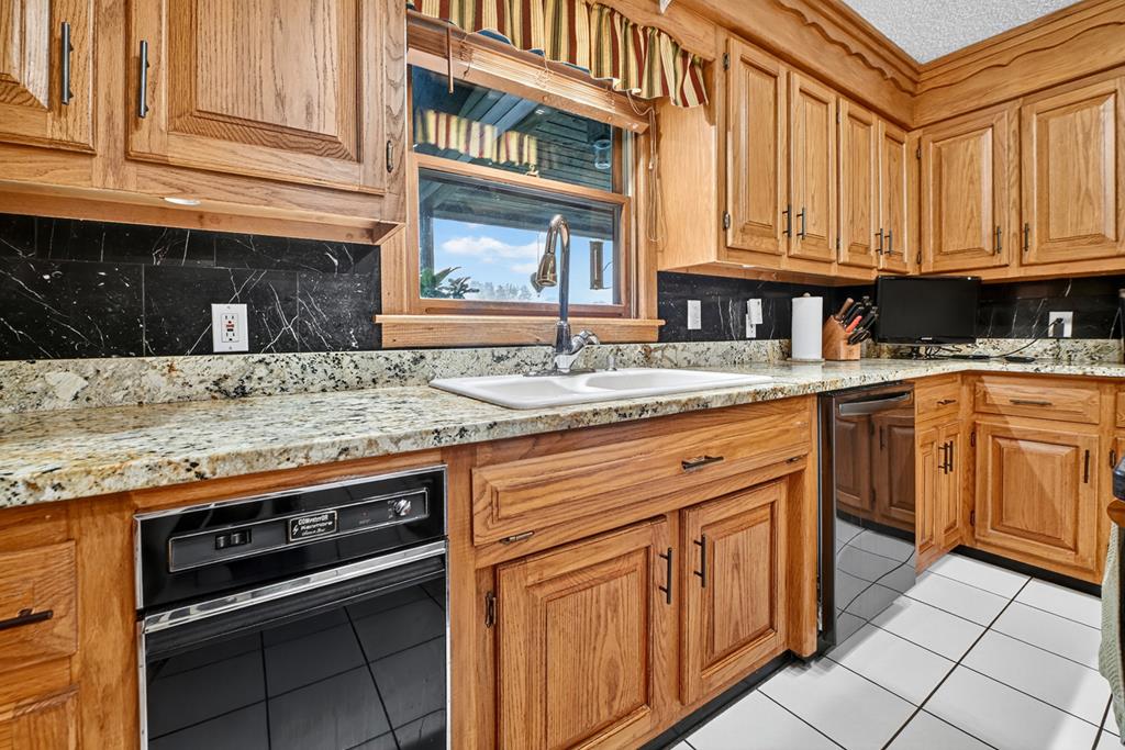 167 Whispering Pne Lane Cherry Log, GA 30522 - Photo 32 of 87 a kitchen with stainless steel appliances granite countertop a sink stove and cabinets