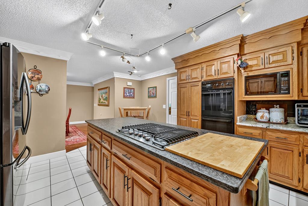 167 Whispering Pne Lane Cherry Log, GA 30522 - Photo 33 of 87 a kitchen with stainless steel appliances granite countertop a stove a sink dishwasher and cabinets with wooden floor