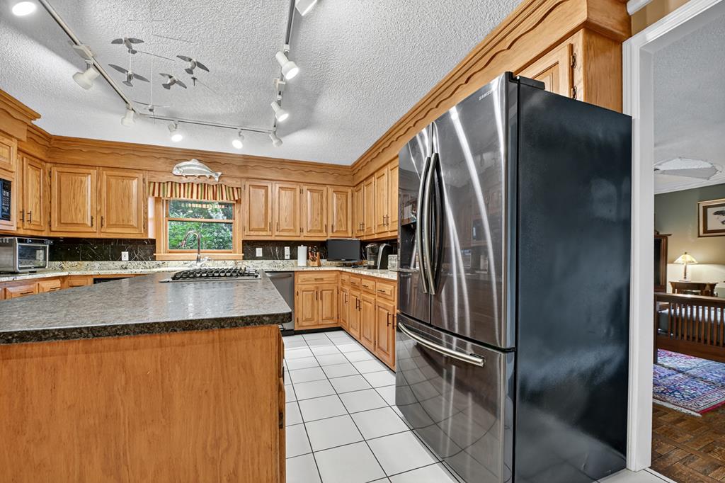 167 Whispering Pne Lane Cherry Log, GA 30522 - Photo 34 of 87 a kitchen with stainless steel appliances granite countertop a refrigerator a sink a stove and dishwasher