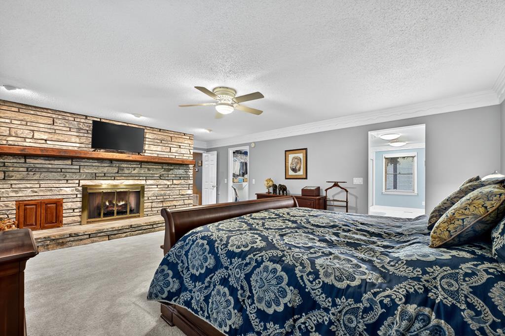 167 Whispering Pne Lane Cherry Log, GA 30522 - Photo 42 of 87 a bedroom with a large bed and a fireplace