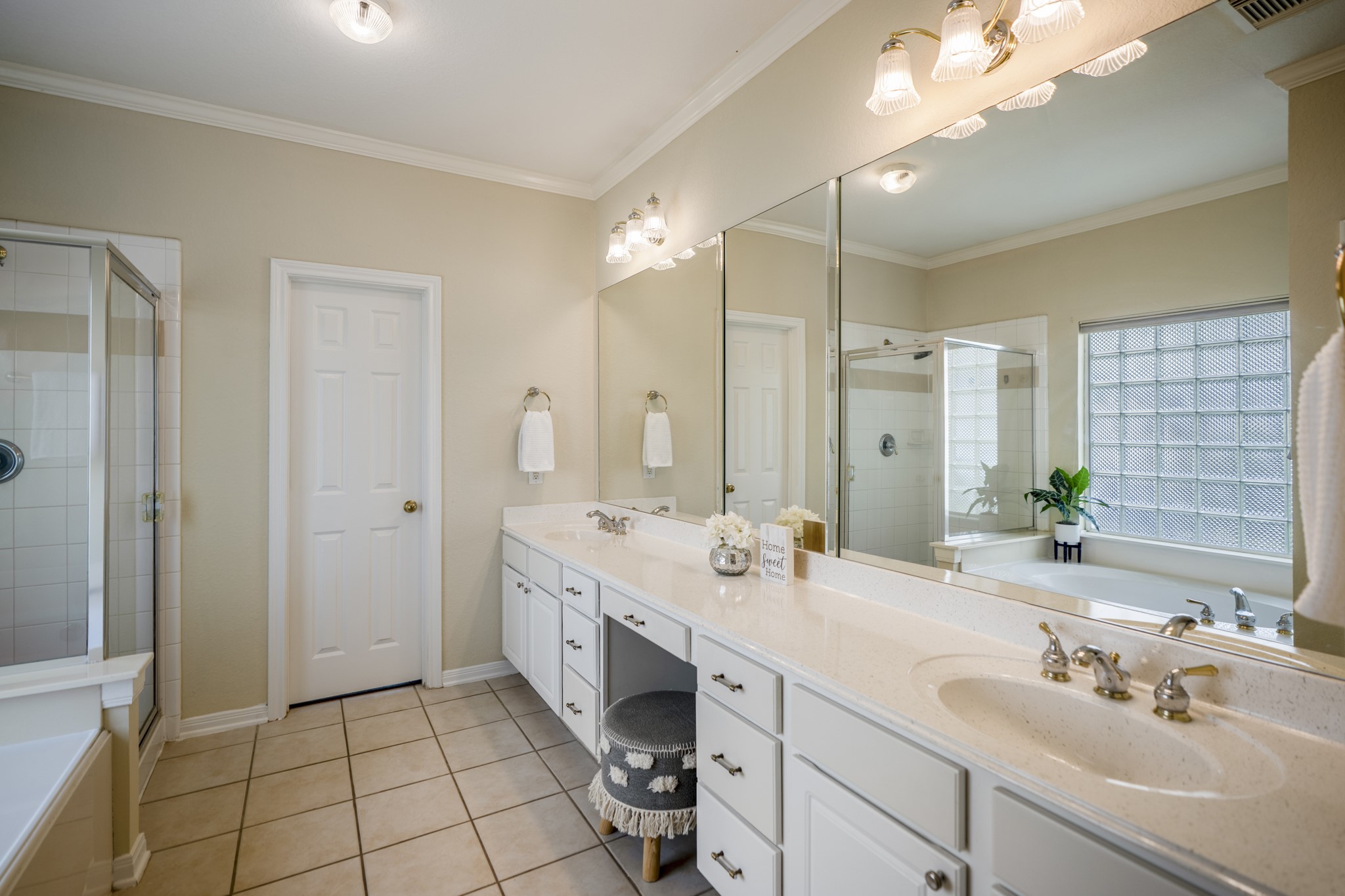 5807 Sequoia Trace Court Spring, TX 77379 - Photo 16 of 50 The primary bath offers an extended vanity with dual sinks, abundant storage, a soaking tub, and a separate shower, creating a practical, well-appointed space connected directly to the downstairs primary suite.