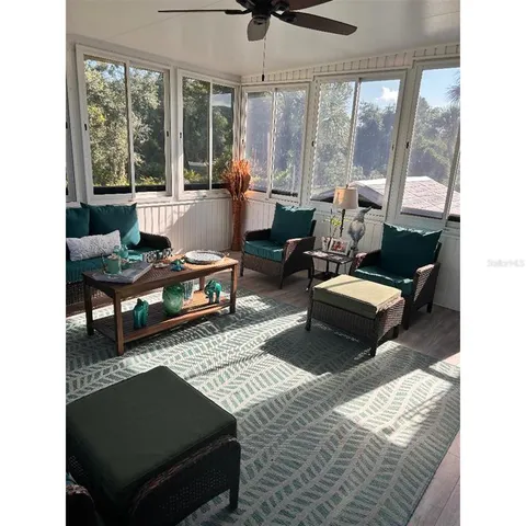 a living room with furniture rug and large window