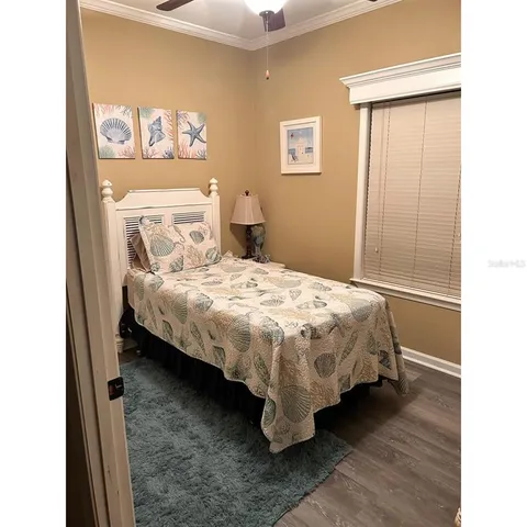 a bedroom with a bed and painting on the wall