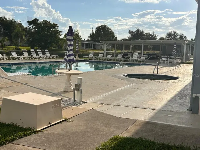 a view of a swimming pool and a yard