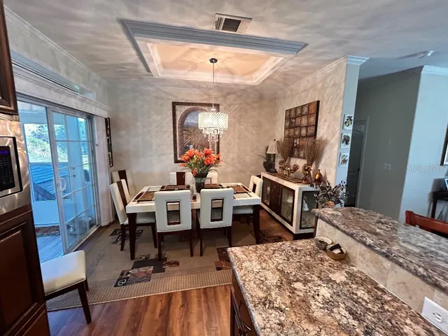 a living room with furniture flat screen tv and a table