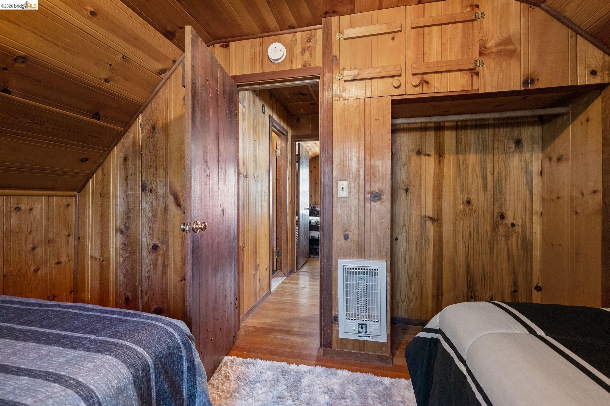 26175 Janice Way Long Barn, CA 95335 - Photo 18 of 23 Bedroom featuring a vaulted wooden ceiling, wood finished floors, heating unit, and wooden walls