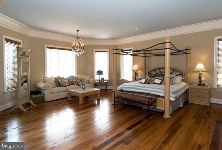 905 Hayfields Road Cockeysville, MD 21030 - Photo 7 of 17 a bedroom with furniture and a chandelier