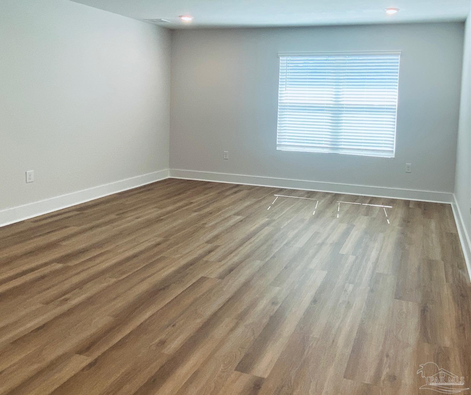 3021 Serviceberry Road Cantonment, FL 32533 - Photo 6 of 21 a view of an empty room with wooden floor and a window