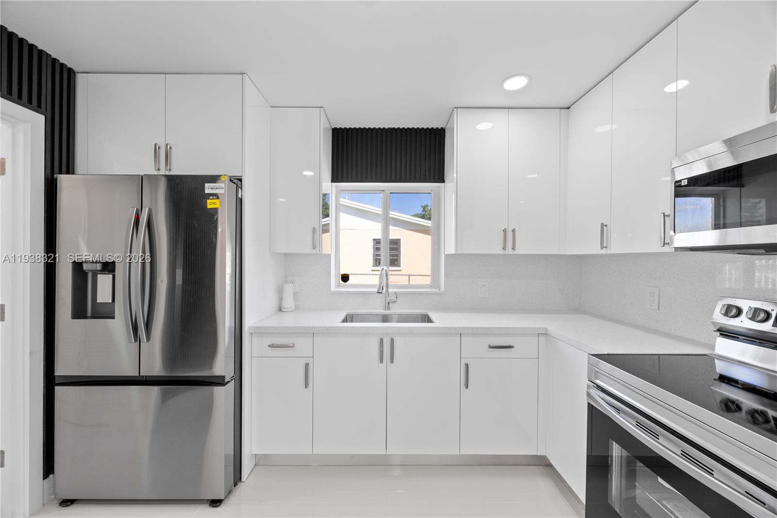 22503 Southwest 113th Place Miami, FL 33170 - Photo 20 of 35 a kitchen with stainless steel appliances a refrigerator sink and microwave