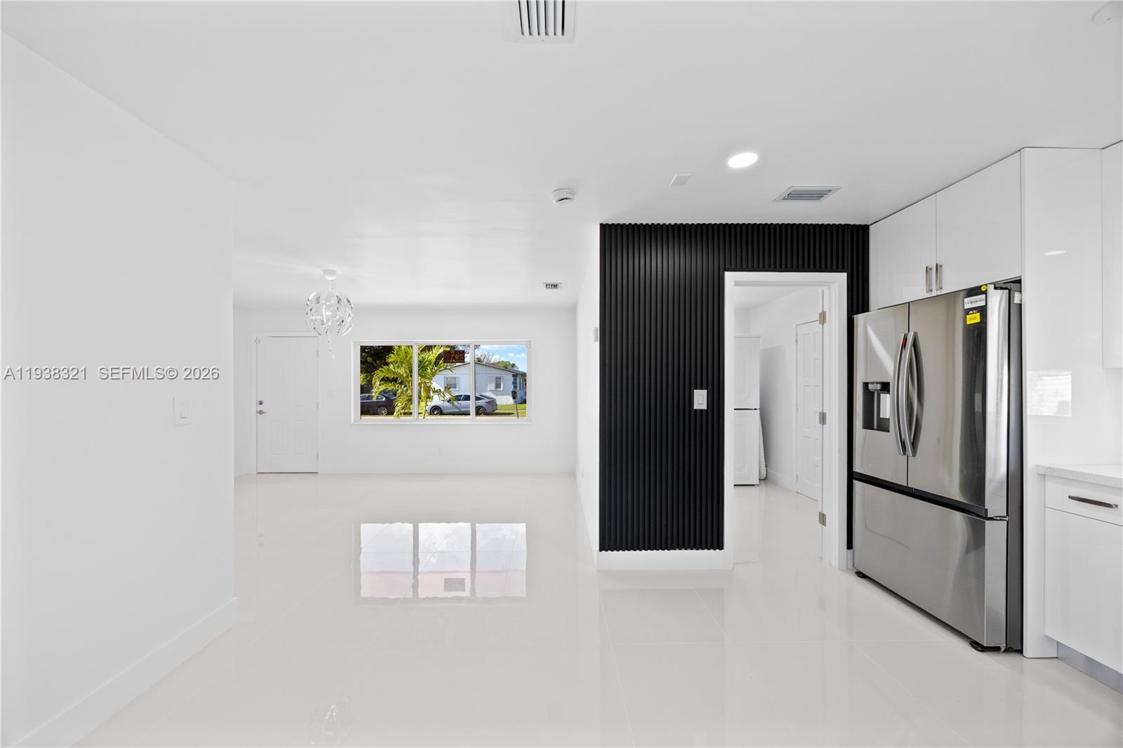 22503 Southwest 113th Place Miami, FL 33170 - Photo 21 of 35 a view of a refrigerator in kitchen and an empty room