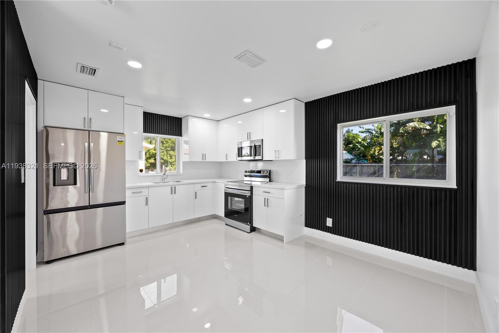 22503 Southwest 113th Place Miami, FL 33170 - Photo 3 of 35 a kitchen with white cabinets and stainless steel appliances