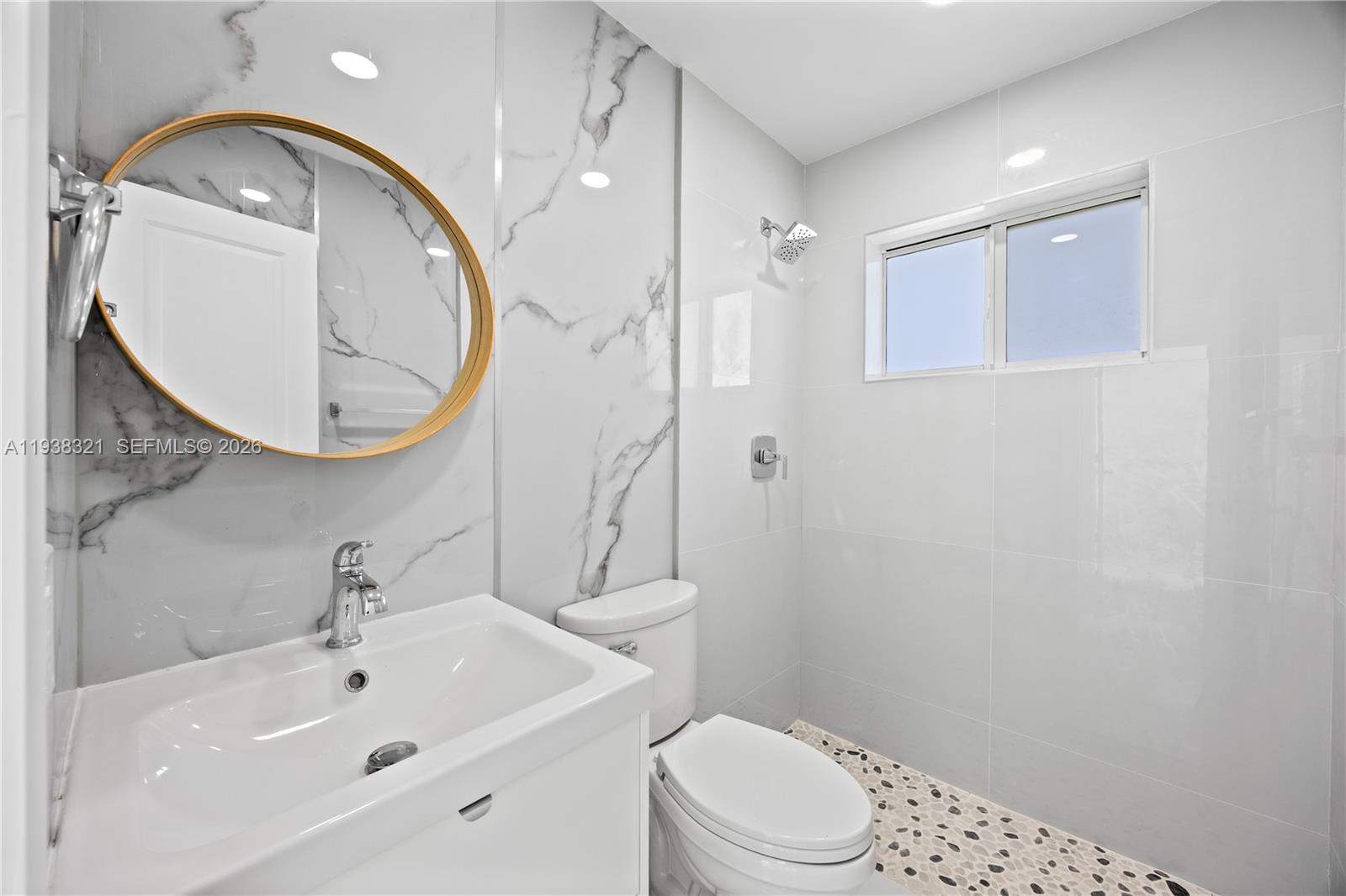 22503 Southwest 113th Place Miami, FL 33170 - Photo 4 of 35 a bathroom with a sink a mirror a toilet and a mirror
