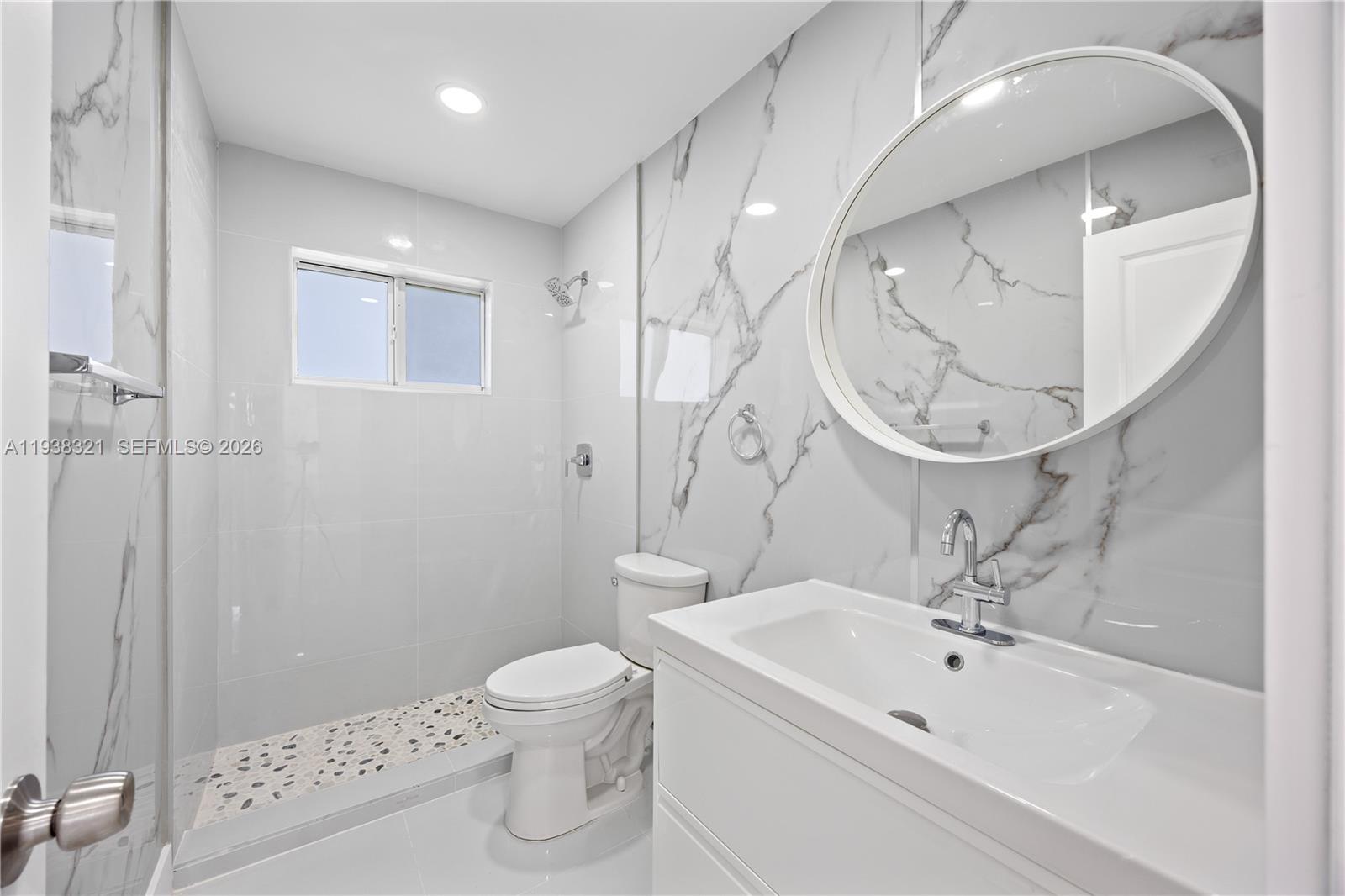 22503 Southwest 113th Place Miami, FL 33170 - Photo 7 of 35 a bathroom with a sink a toilet and a mirror